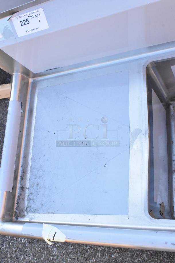 BRAND NEW SCRATCH AND DENT Regency 600S21717218 stainless steel 2 bay sink with dual drain boards, auction tag visible.