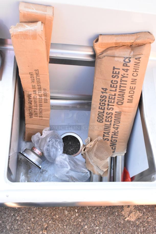 BRAND NEW SCRATCH AND DENT! Regency 600S21717218 stainless steel 2-bay sink with dual drain boards, packaging shown.