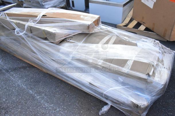 5 brand new scratch and dent items including a Regency double aluminum swinging traffic door and a stainless steel work table, packaged.