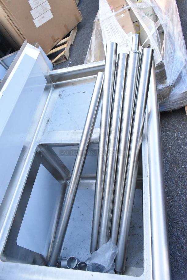 BRAND NEW Regency 600S41818218 stainless steel four-compartment sink, 16 gauge, with two drainboards, no legs, slight scratches.