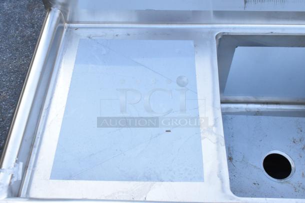 BRAND NEW SCRATCH AND DENT Regency 600S41818218 stainless steel four-compartment commercial sink. No legs, visible scratch.
