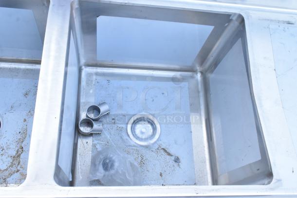 BRAND NEW SCRATCH AND DENT Regency 600S41818218 stainless steel commercial sink, four compartments, two drainboards, no legs.