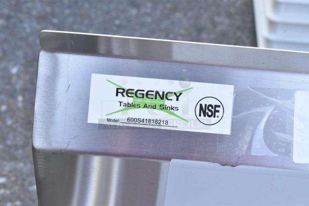 Regency stainless steel four-compartment sink with two drainboards, model 600S41818218, brand new, light scratches visible.