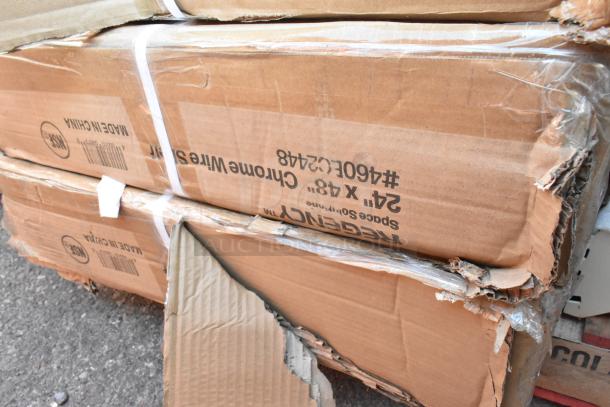 Boxes of Regency 24" x 48" chrome wire shelves, visible dents in packaging. Marked "NSF" and "Made in China."