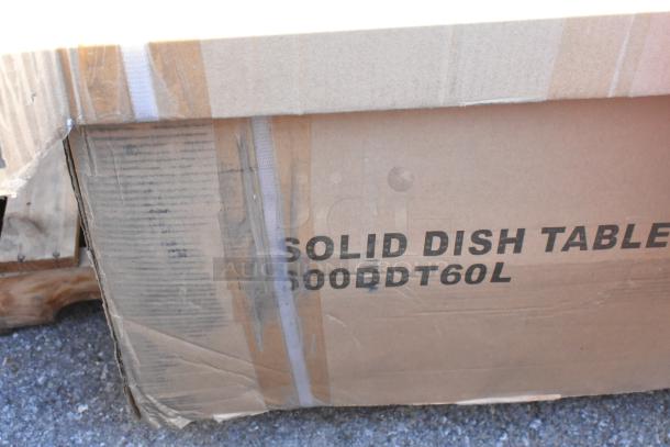 Cardboard box labeled "600DDT60L Solid Dish Table" with visible wear, indicating new Regency dish table inside.
