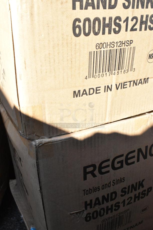 Two stacked boxes labeled "600HS12HSP" from Regency, containing wall-mounted hand sinks, marked "Made in Vietnam."