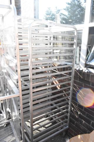 2 metal pan transport racks on commercial casters, sturdy condition, ideal for kitchen use, numbered tag visible.