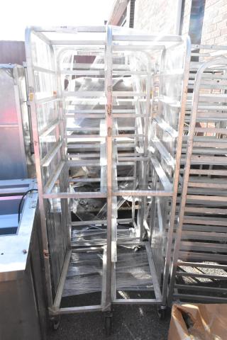 3 metal pan transport rack on commercial casters. Durable construction, suitable for kitchen use. Good condition.