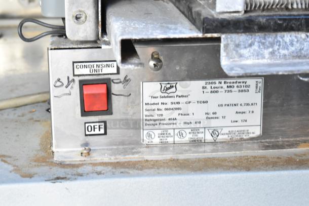 Metal panel of Duke SWD600-600FL Subway Sandwich Salad Prep Line with model SUB-CP-TC60 details and power switch.