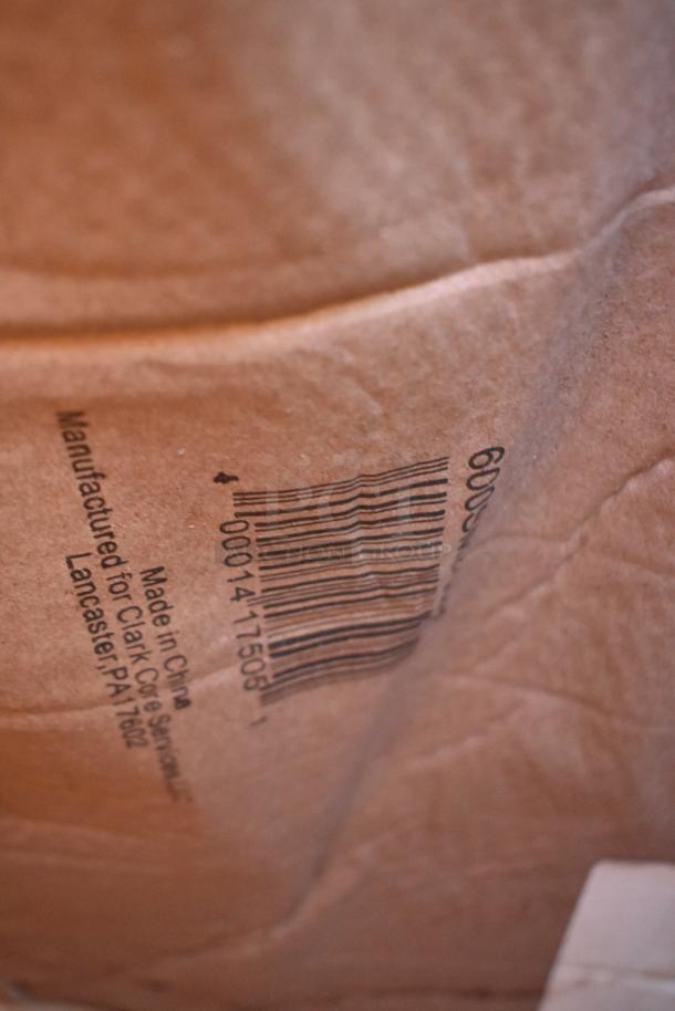 Close-up of a cardboard box showing a barcode and "Made in China" text. Condition appears slightly dented.