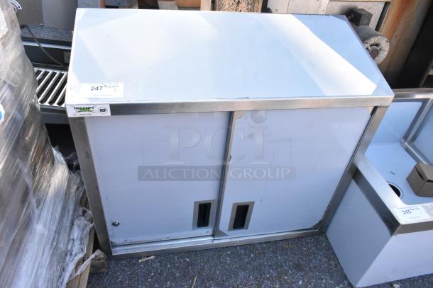 BRAND NEW SCRATCH AND DENT Regency 600WCS1536 36" stainless steel wall cabinet with sliding doors, small scratches visible.