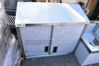 BRAND NEW SCRATCH AND DENT Regency 600WCS1536 36" stainless steel wall cabinet with sliding doors, small scratches visible.