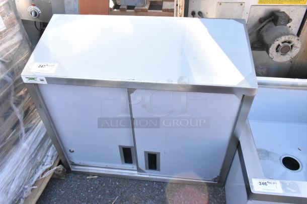 "Regency 600WCS1536 36-inch stainless steel wall cabinet with sliding doors, brand new scratch and dent, visible cosmetic damage."