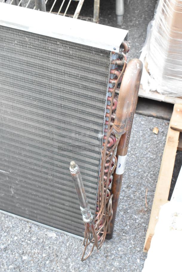 Nationwide Coils evaporator coil with copper tubing, metal fins. Appears in used condition. Markings visible on pipes.