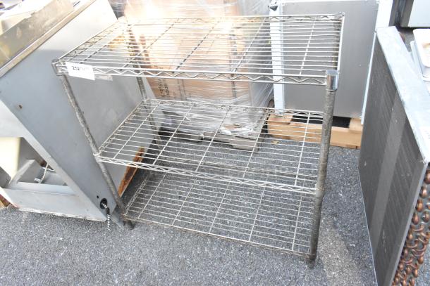Chrome finish 3-tier shelving unit, slightly rusted, with buyer dismantling required. Consider freight charges for shipping.