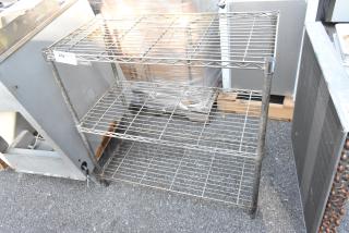 Chrome finish 3-tier shelving unit, slightly rusted, with buyer dismantling required. Consider freight charges for shipping.