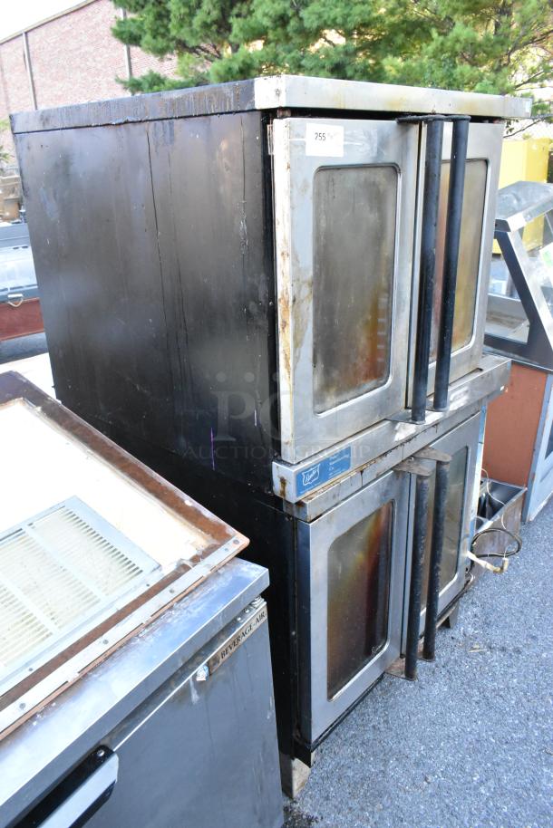 2 Duke stainless steel commercial convection ovens, view-through doors, metal racks, thermostatic controls, moderate wear.