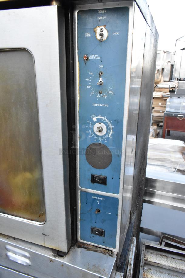 Duke stainless steel convection oven with view-through door, metal racks, thermostatic controls; used condition, visible wear.