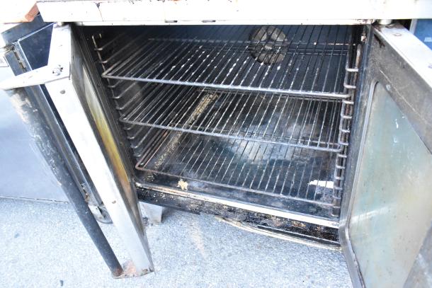 Duke stainless steel commercial convection oven with view-through door, metal racks, thermostatic controls, used condition.