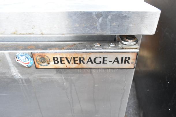 Beverage Air SPE72HC-18 stainless steel prep table with visible USA-made and brand labels, on casters, showing wear.
