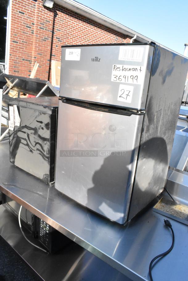 Two mini coolers, including Hisense WMS017M6XBE and Willz 7716231 with freezer, 115V, 1 phase, displayed on a metal surface.