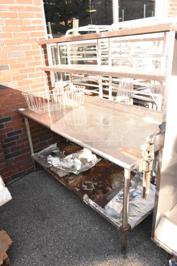 Stainless steel table with two-tier over shelf, under shelf, and mounted commercial can opener. Weathered condition.