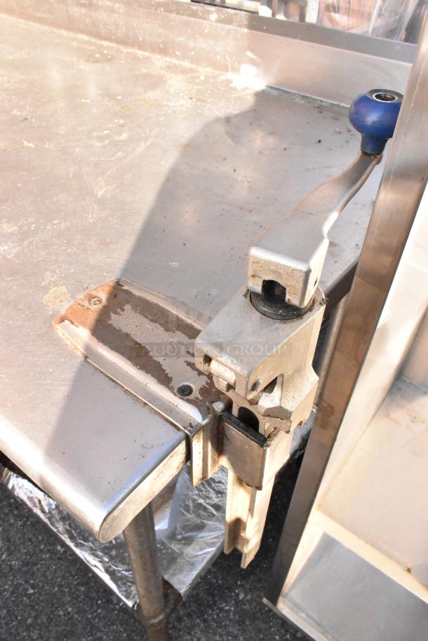 Stainless steel table with 2-tier over shelf, under shelf, and mounted commercial can opener. Used condition.