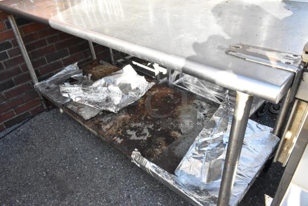 Stainless steel table with 2-tier over shelf, under shelf, and mounted commercial can opener. Some rust and wear visible.