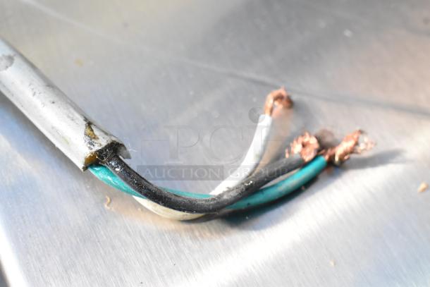 Damaged power cord of a Magic Chef MCO160UB microwave oven. Exposed copper wires indicate need for repair.