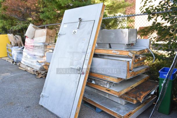 Harford Walk In Box with Bohn 115V, 1 Phase Evaporator Fan. Used condition with visible exterior door and panels stacked.