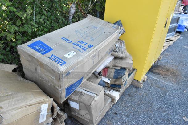 Twenty new scratch and dent items, including gray trash can and towel dispensers in damaged boxes on a pallet.