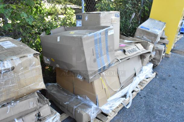 Boxes of brand new scratch and dent items, including a table and wall cabinet, stacked on pallets. Markings show "FRAGILE."