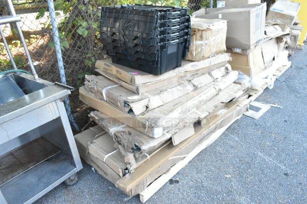 15 brand new scratch and dent items, including a table, wire shelf, drying rack, in damaged packaging on a pallet.