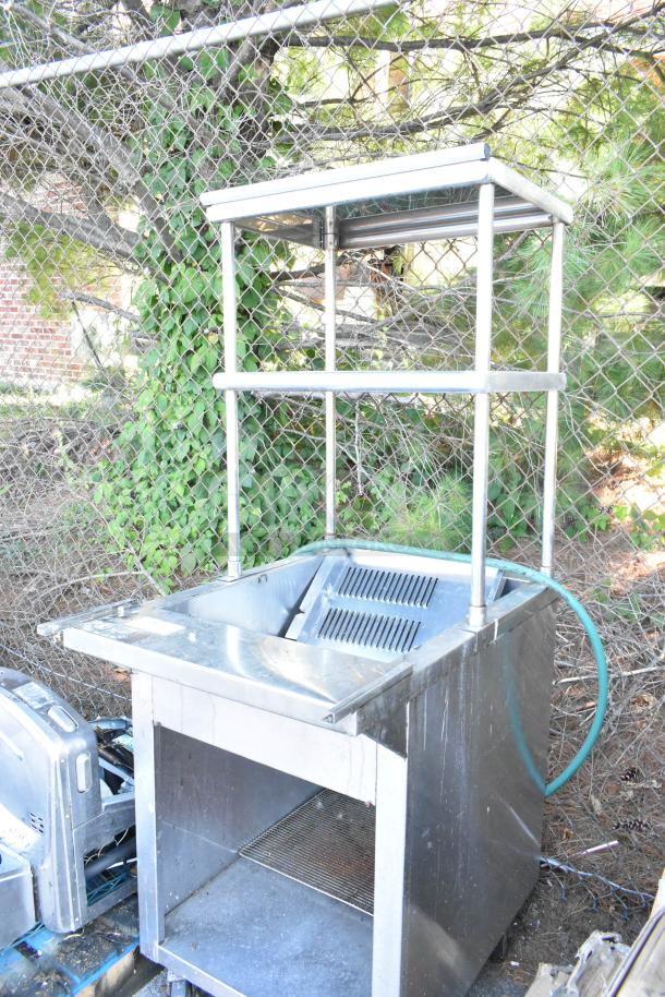 Stainless steel steam table with two-tier over shelf and metal under shelf on commercial casters; used condition.