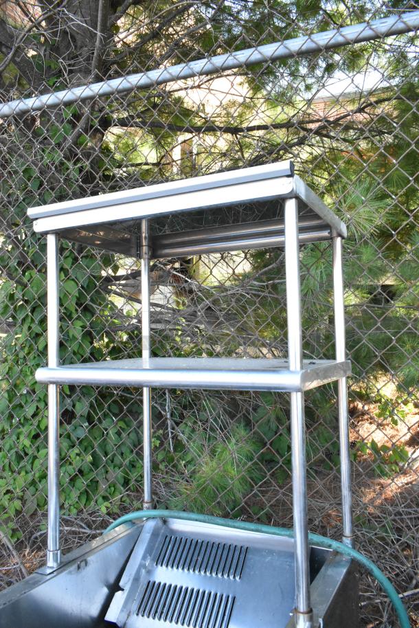 Stainless steel steam table with 2-tier over shelf, metal under shelf, and commercial casters. Appears in good condition.