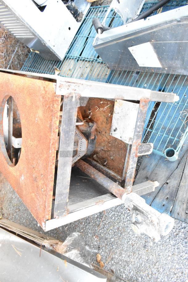 Rustic metal commercial gas-powered 2 tier, 2 burner range. Shows signs of wear and rust. Ideal for restoration.