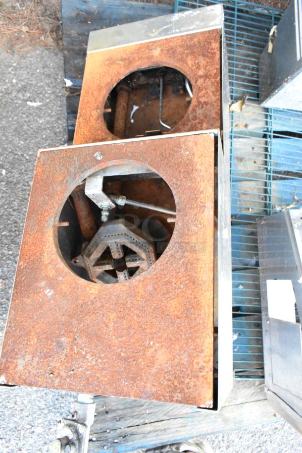Metal Commercial Gas Powered 2 Tier 2 Burner Range; rusted surface, industrial design, visible burner components, needs refurbishing.