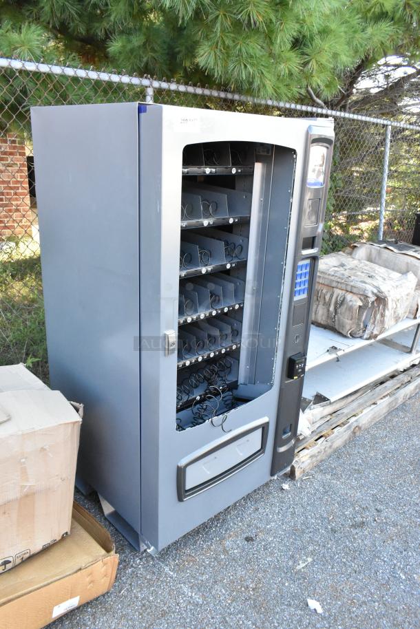 Seaga ENV4S vending machine with broken glass, 32-item capacity, credit card reader, 115V, 1-phase. Scratch and dent condition.