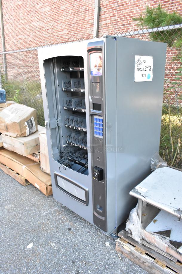 Seaga ENV4S vending machine, brand new but with broken glass. Includes payment acceptor and credit card reader. 115 volts, 1 phase.