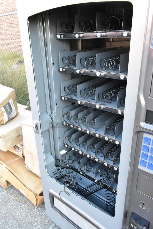 Seaga ENV4S vending machine, 32-item capacity, with Seaga payment acceptor and credit card reader. Broken glass visible.