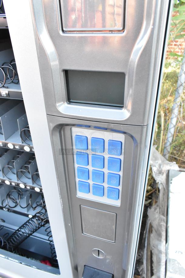 Seaga ENV4S vending machine with credit card reader, blue keypad. New with dent, broken glass visible. 115V, 1 phase.
