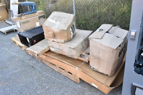 Eight boxes labeled "Scratch and Dent" from Seaga, including work table, over shelf, dish machine stand, seen on a pallet.