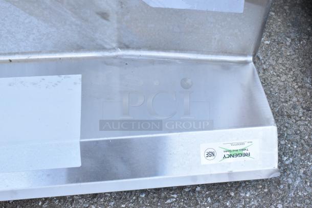 BRAND NEW SCRATCH AND DENT Regency 600DDTI72L 6' 16-Gauge Stainless Steel Soiled L-Shape Dishtable, no legs, NSF label visible.