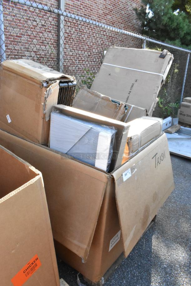 8 Seaga scratch and dent items, including work table, wire shelf, and pasta station base in boxes. Some wear visible.