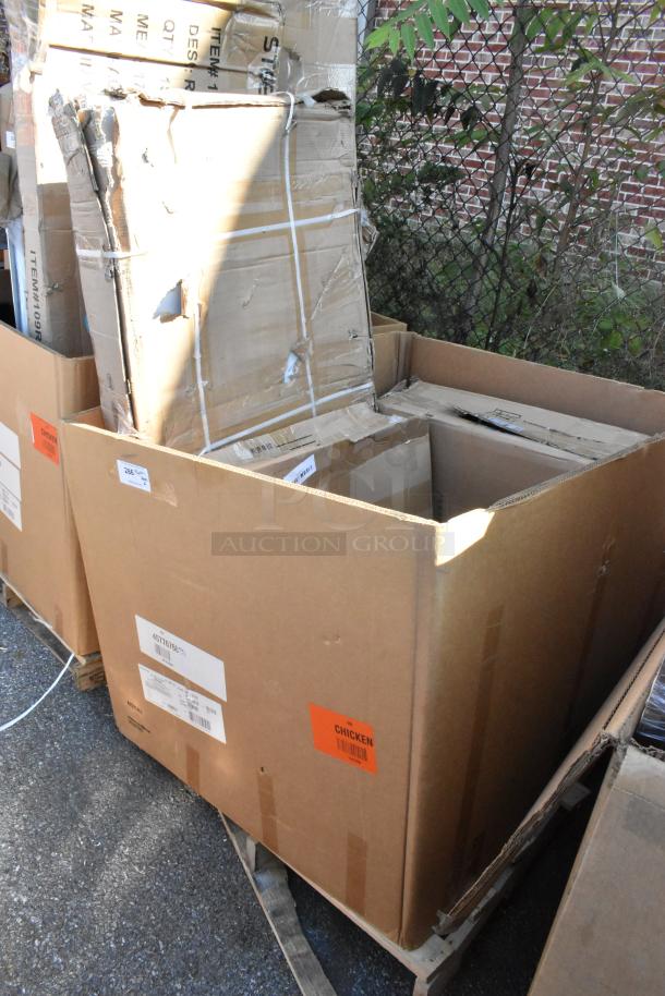 6 new Seaga scratch and dent items, including table base plate and enclosed base, in large cardboard boxes. Labels visible.