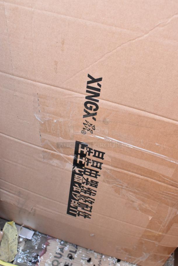 Seaga items in box labeled "XINGX," brand new with scratch and dent condition. Includes table base plate and enclosed base.