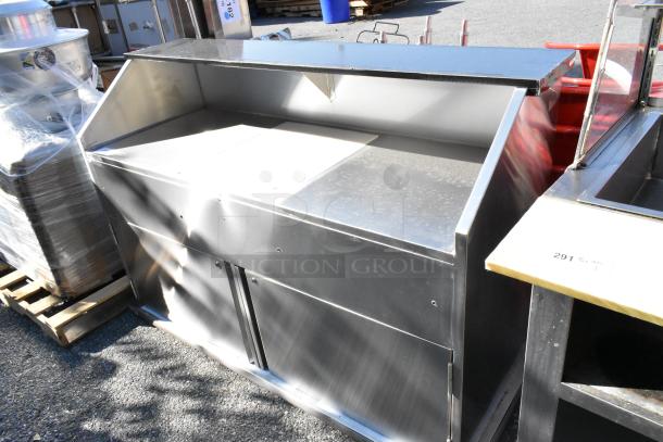 Brand new Regency 600PB63S 63" stainless steel portable bar with two speed rails and ice bin, showing minor scratches.