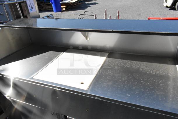Brand new Regency 600PB63S 63" portable stainless steel bar with two speed rails, ice bin, and cover. Scratch and dent condition.