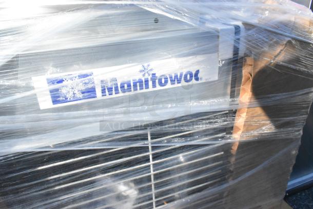 Canarm ALX120-UD-EC exhauster and Manitowoc remote compressor wrapped in plastic. Visible Manitowoc branding.