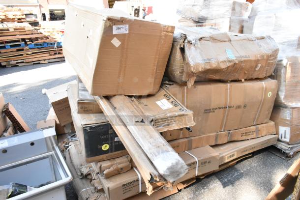 15 brand new boxes, including dirty dish table and wire shelf, stacked with visible labels; some boxes damaged.